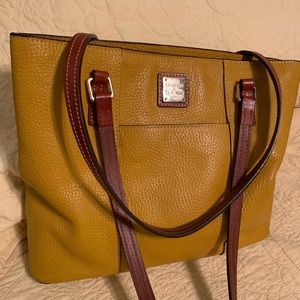 Gold colored Dooney & Bourke pebble grain Lexington purse. Very good condition.